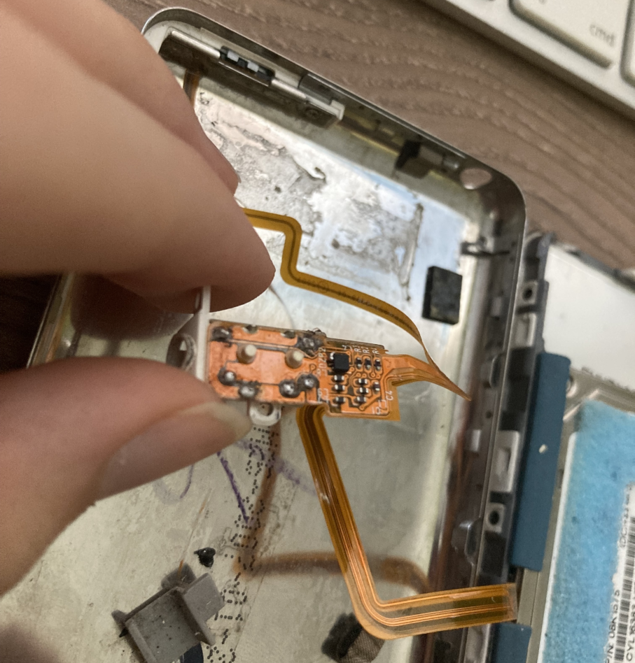 Picture of me holding the headphone jack assembly, showing the solder joins